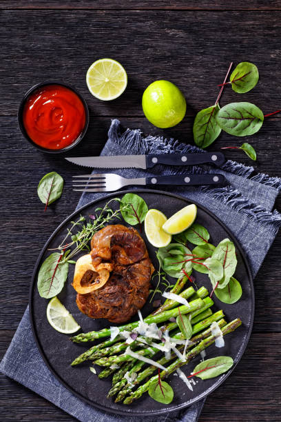 istock braised osso buco with grilled asparagus, top view 1408075424