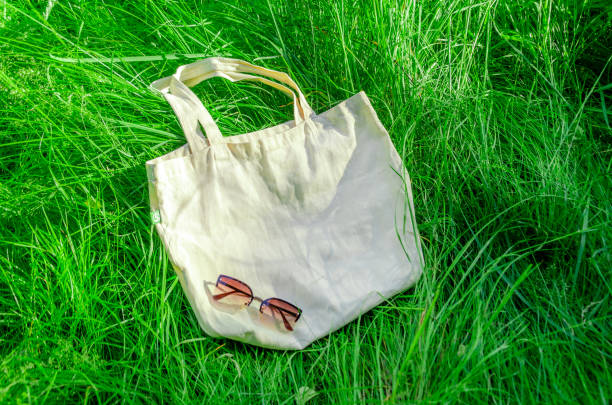 istock cotton shopping bag on green grass background. Zero waste, no plastic, eco friendly. template 1408076816