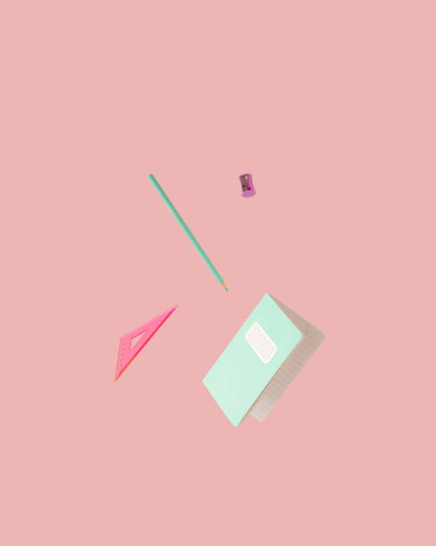 istock School supplies. Pastel green crayon and notebook, pink triangle ruler and pencil sharpener floating against pink background. 1408080404