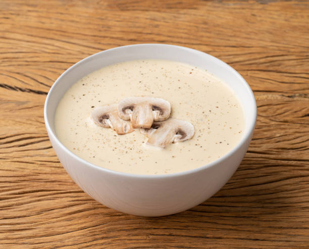 istock Mushroom soup in a bowl over wooden table 1408085397