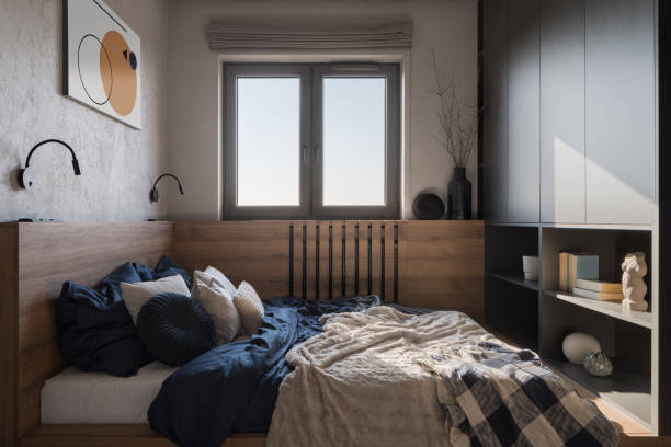 Small and comfortable bedroom with window Small and comfortable bedroom with cozy bed, wooden decor, bookshelf and window head board bed blue stock pictures, royalty-free photos & images