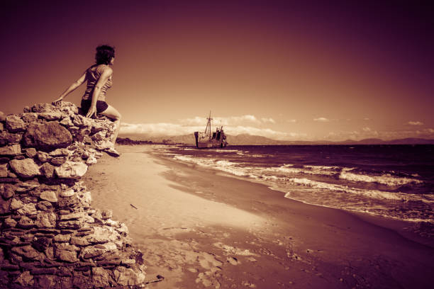 Standing alone on the beach, watching the ship in the morning light