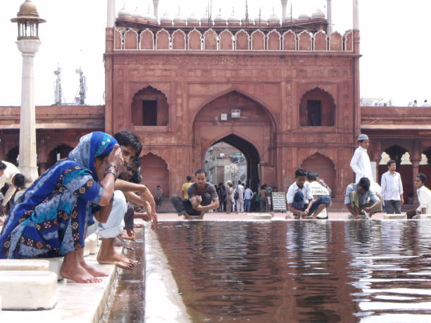 Jama Masjid Mosque, New Delhi, India, August 9, 2011: Many worshipers perform their ablutions in the designated area next to the main entrance of the Jama Masjid Mosque in New Delhi, India