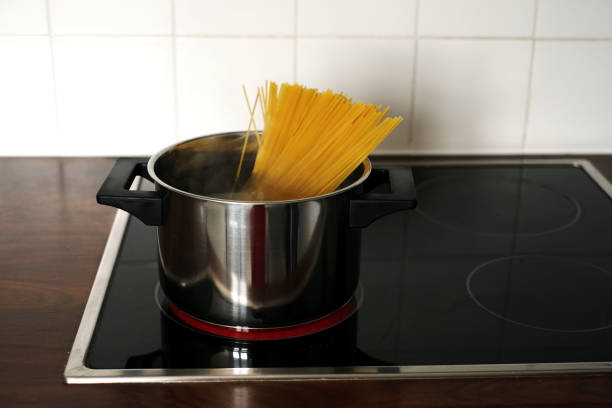 istock spaghetti in a pan on an induction stove close-up 1408091530