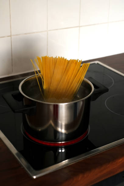 istock spaghetti in a pan on an induction stove close-up 1408091641