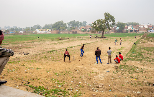 02-14-2019  Agra, India. homegrown baseball in Agfa. Houses in distance - poverty.  I suppose  that there no stoves (for cooking) and plumbing