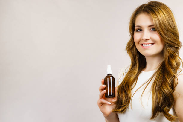 istock Woman applying hair cosmetic 1408091765