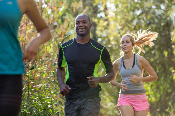 istock Group of adults running outside together 1408093739