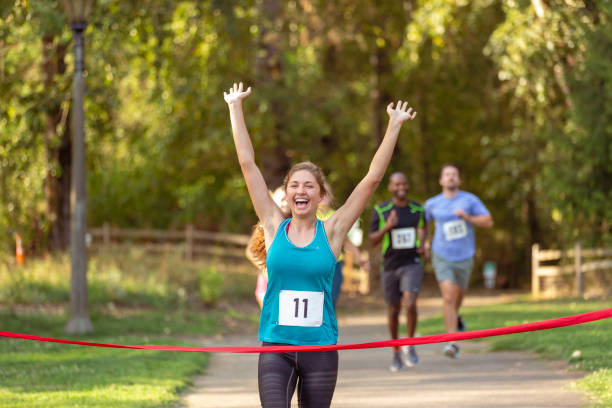 istock Female runner crossing finish line in race 1408093757