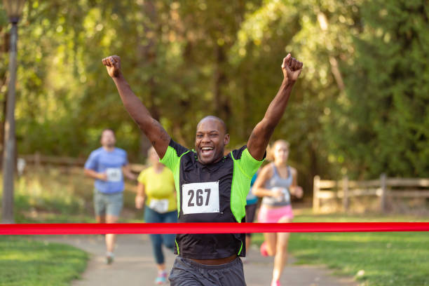 istock Excited runner crossing the finish line 1408093772