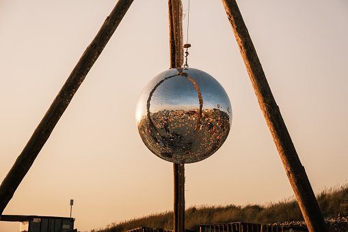 Mirror ball on the beach at a sunset concert