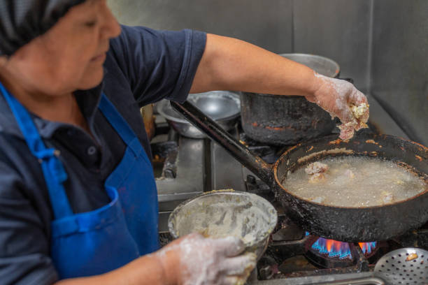 istock Cook frying meat in a kitchen 1408097314