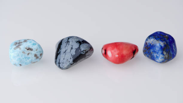 four different gemstones in a row against white background stock photo
