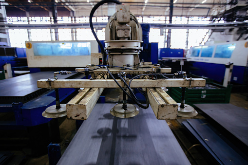 Picture of a Laserpress machine feeding and cutting a sheet of steel.