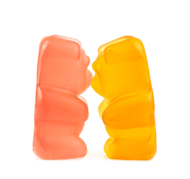 istock Two kissing jelly bears isolated on a white background. Colored marmalade bears. 1408099513
