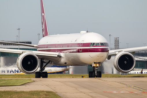 Manchester Airport, United Kingdom - 16 June 2022: Qatar Airways Boeing 777 (A7-BAC 25 Years of Service retro livery) taxiing towards runway 23L for take off to Doha, Qatar.