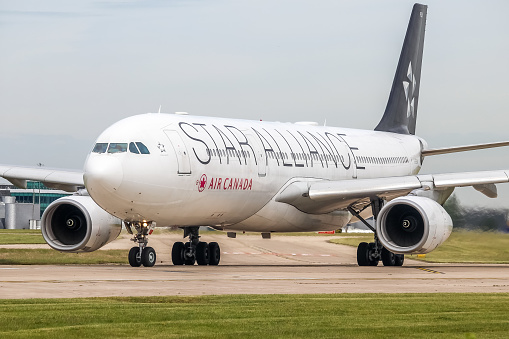 Manchester Airport, United Kingdom - 16 June 2022: Air Canada Airbus A330 (C-GHLM Star Alliance) entering ruwnay 23L for take off to Toronto (YYZ), Canada.