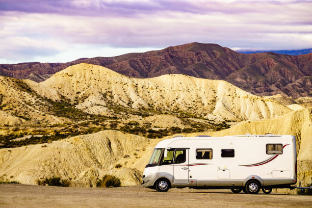 a recreational vehicle parked near mountains