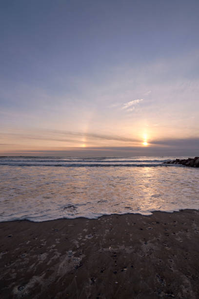 istock Sunrise from the beach with a breakwater 1408102866