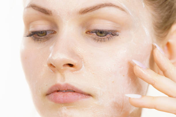 istock Girl with cream moisture cosmetic on face 1408103646