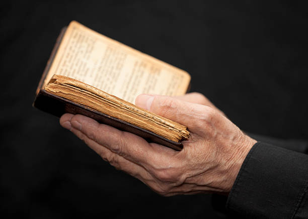 istock Hands of an old man holding a book 140810451
