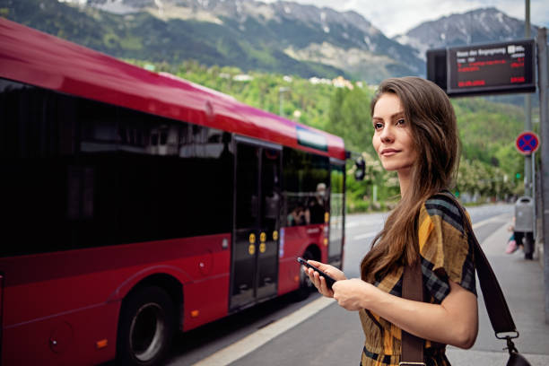 Portrait of young woman waiting on the bus station stock photo