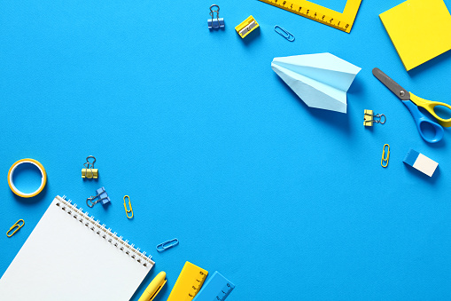 Flat lay school stationery and accessories on blue background. Back to school banner design