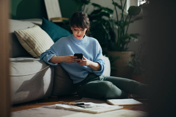 Beautiful Woman Using Mobile Phone At Home