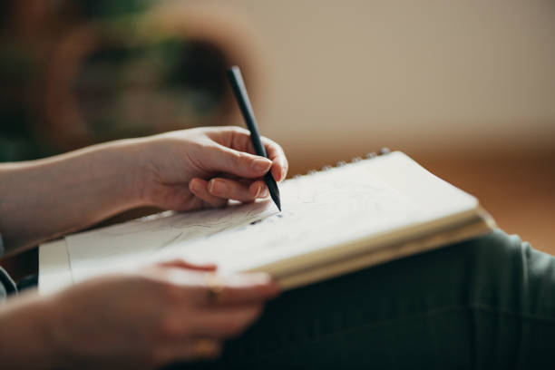 istock An Anonymous Woman Drawing Sketch In Her Notebook At Home 1408110275
