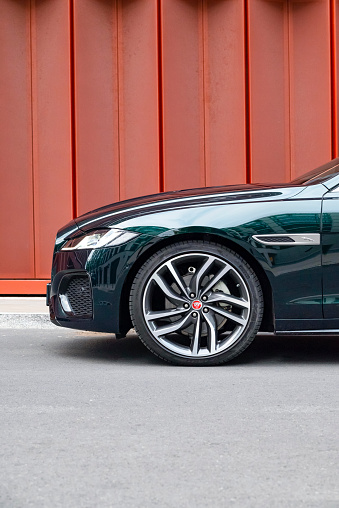 Berlin, Germany - 19th July, 2021: Alloy wheel in Jaguar XF on a street. This model is one of the most popular vehicles in Jaguar offer.