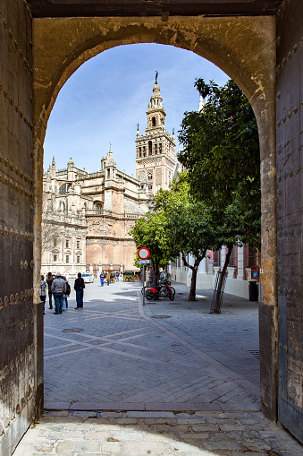 Seville, Spain - March 15, 2013: View of Seville Cathedral through old gate