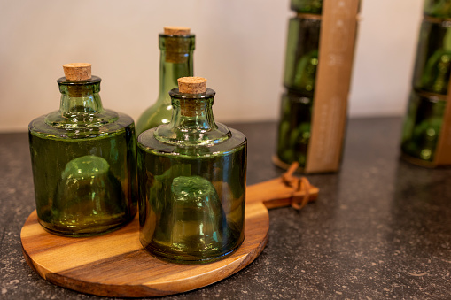 Unusual green bottles stand on a wooden stand