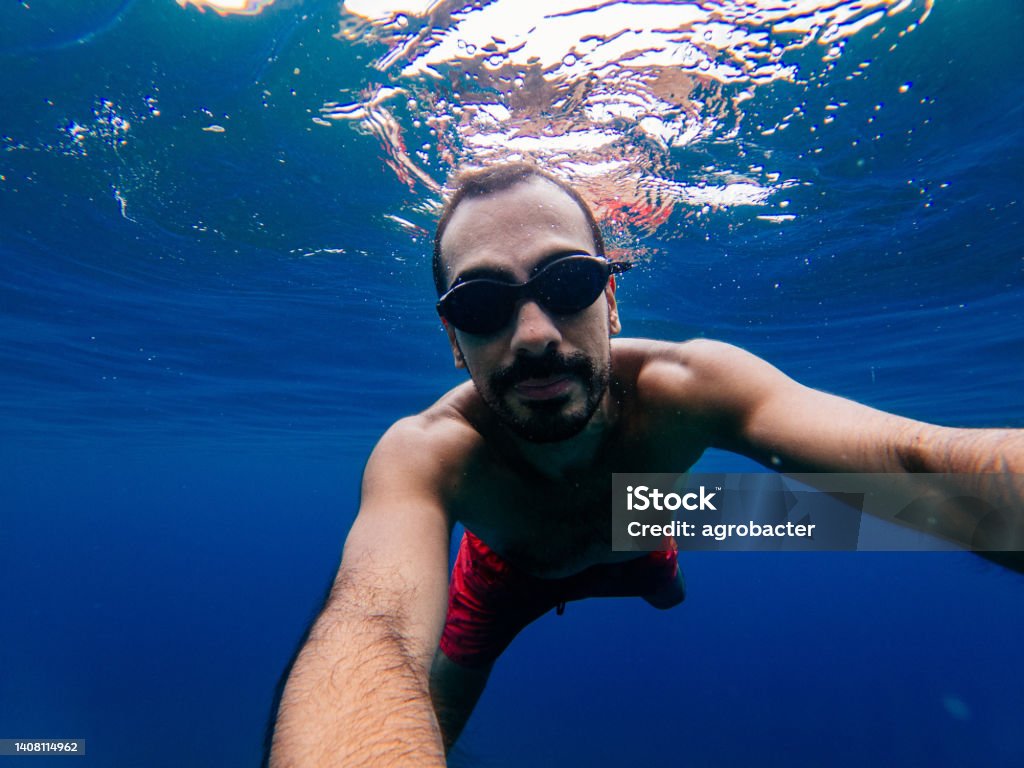 Man enjoying at sea Underwater Stock Photo