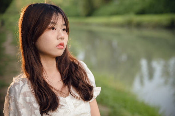 istock Asian girls by the river 1408121671