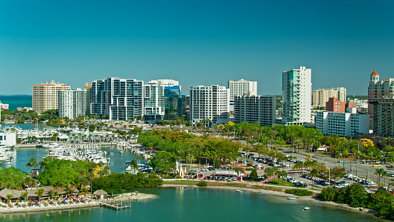 Aerial shot of Sarasota, Florida on a bright and sunny spring day. Sarasota is a coastal town in the gulf area known as a popular tourist destination.\n\nAuthorization was obtained from the FAA for this operation in restricted airspace.