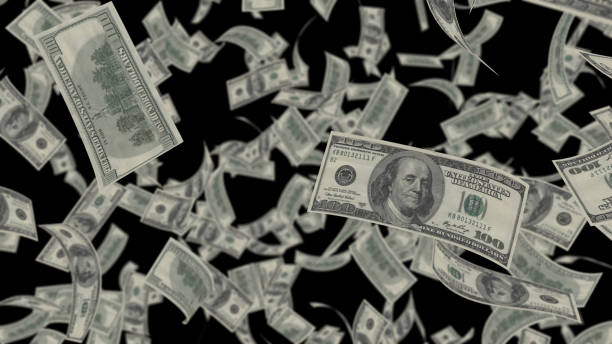 istock Falling Dollar bills banknotes falling rain isolated transparent on black screen background. 1408124277