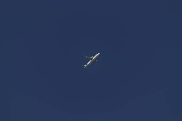 Jet plane crossing a cloudless cobalt blue sky - POA, SAO PAULO, BRAZIL.