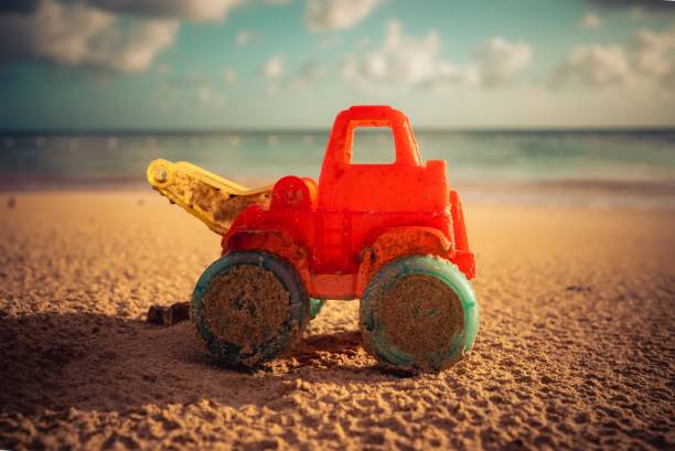 istock Toy truck on a sandy beach 1408125999