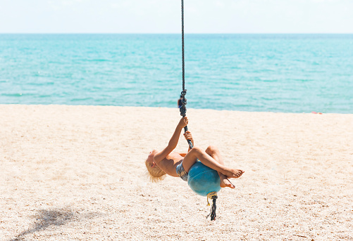 Boy having fun on tropical swing