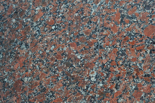 Texture of red spotted granite, natural polished stone, noisy texture Ukrainian granite.