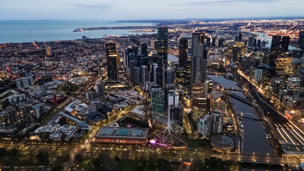 Aerial drone view of Melbourne City, Victoria, Australia looking in the direction of Port Phillip above Yarra River  at dawn stock photo