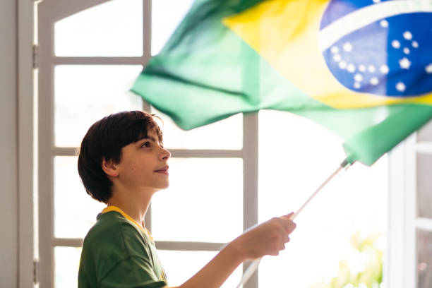 istock Boy holding a Brazilian flag at home 1408130792