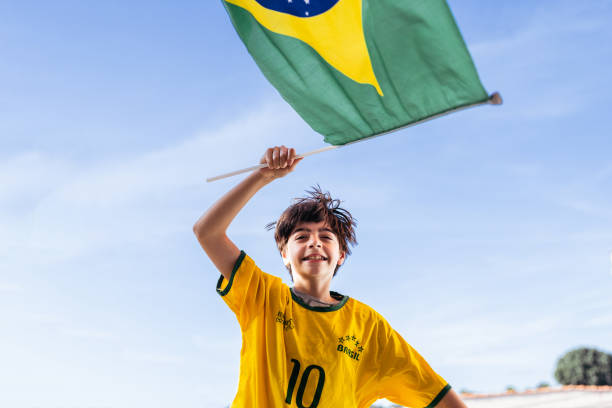 Brazil fan boy running with flag stock photo