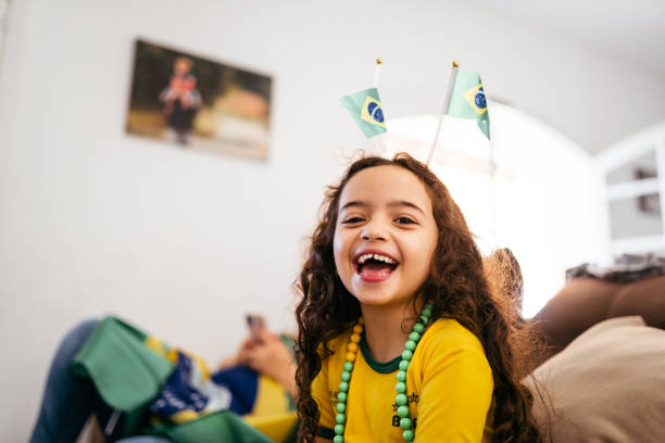 Smiling brazilian girl to watch soccer game stock photo