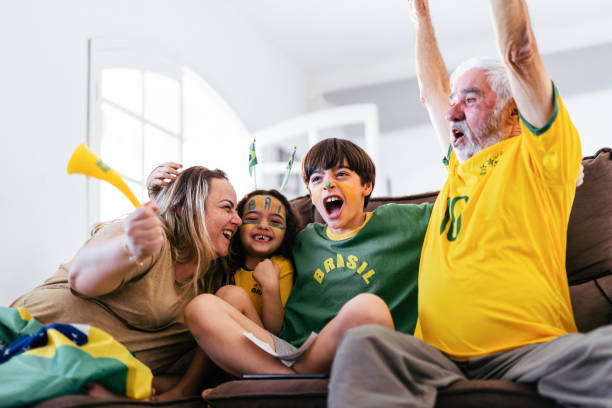 Family at home celebrating a Brazil goal stock photo