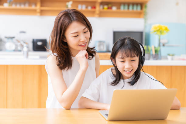 istock girl studying with a PC,correspondence course, mother and daughter 1408132501