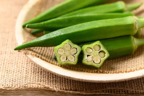 Fresh green okra on natural plate, Organic vegetable, Asian food ingredients