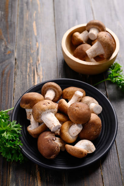 istock Fresh shiitake mushroom on wooden background 1408133388