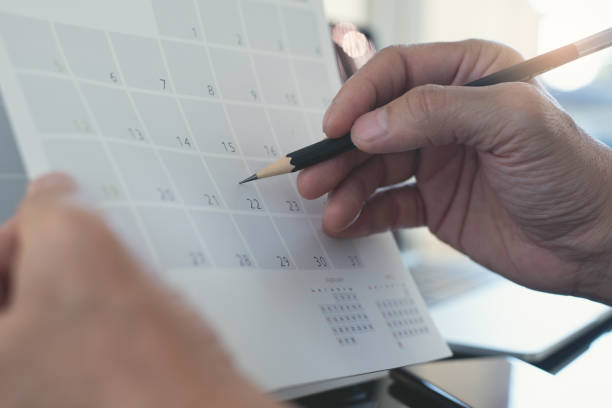 istock Business man planning his work schedule on calendar  event planner, timetable in office 1408134273