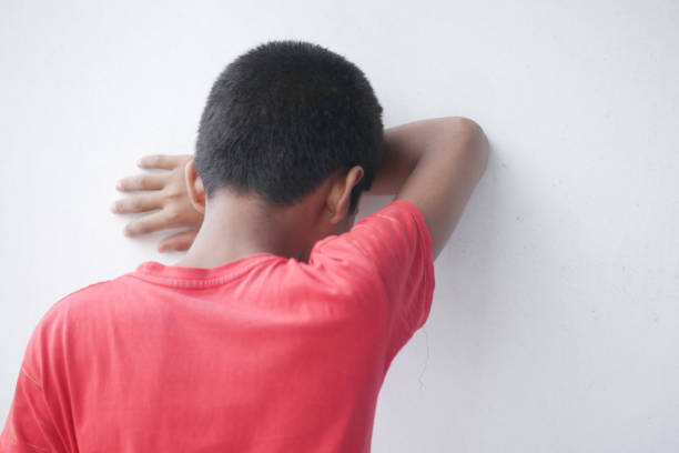 Very dirty African American child with arms crossed - looking angry. Studio shot isolated on a white background.